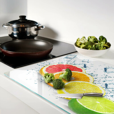 Glass chopping board Citrus fruits in colorful slices