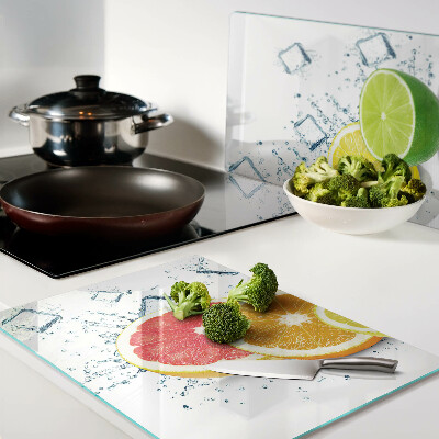 Glass chopping board Citrus fruits in colorful slices