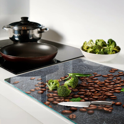 Chopping board glass Coffee beans on a stone background