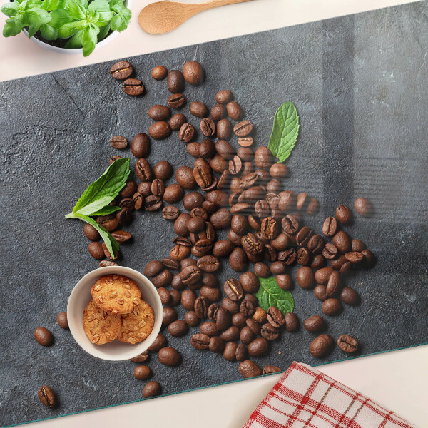 Chopping board glass Coffee beans on a stone background