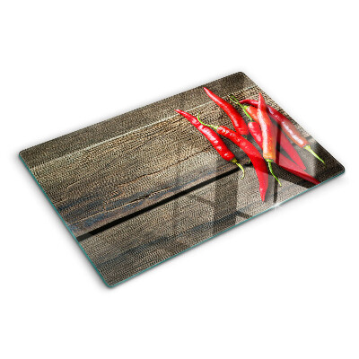 Chopping board Chili peppers on a wooden background