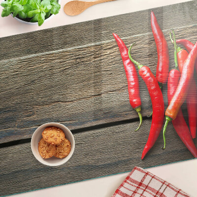Chopping board Chili peppers on a wooden background