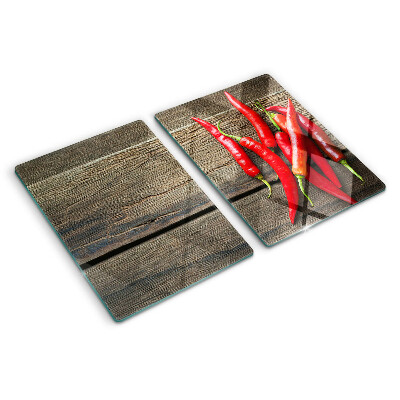 Chopping board Chili peppers on a wooden background