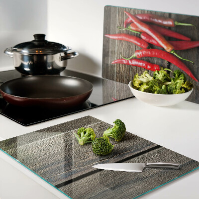 Chopping board Chili peppers on a wooden background