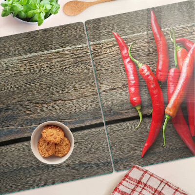 Chopping board Chili peppers on a wooden background