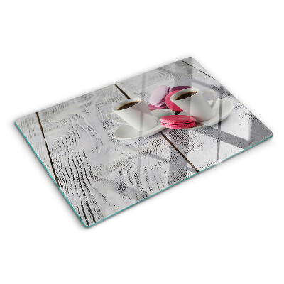 Cutting board Coffee and macaroons on a wooden background