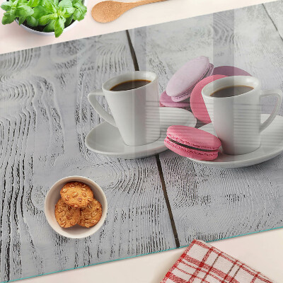 Cutting board Coffee and macaroons on a wooden background