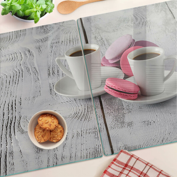 Cutting board Coffee and macaroons on a wooden background