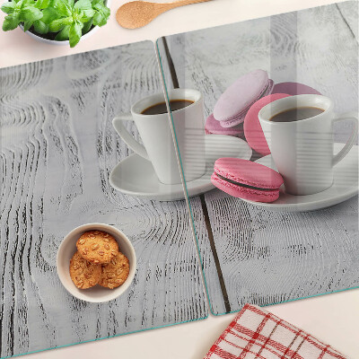 Cutting board Coffee and macaroons on a wooden background