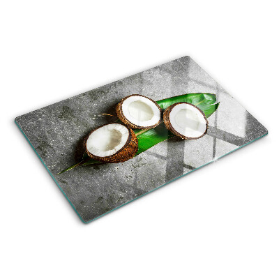 Glass chopping board Coconut on a concrete background