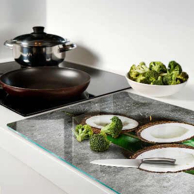 Glass chopping board Coconut on a concrete background