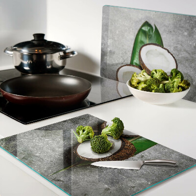Glass chopping board Coconut on a concrete background