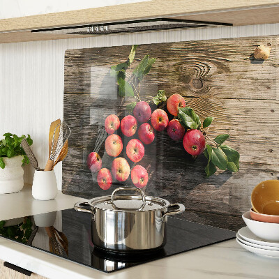 Chopping board glass Apples on a wooden background