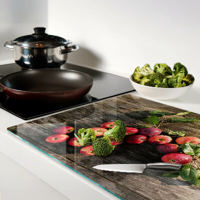 Chopping board glass Apples on a wooden background