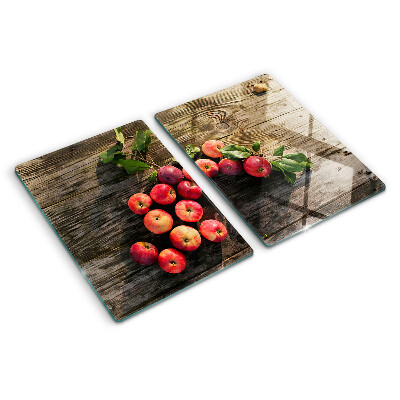 Chopping board glass Apples on a wooden background