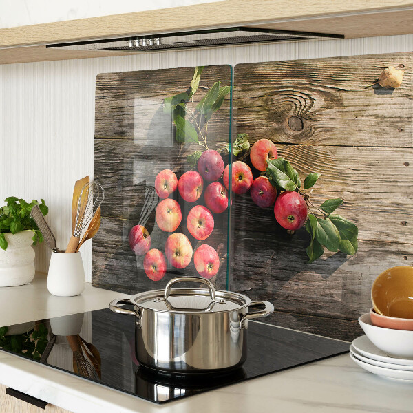 Chopping board glass Apples on a wooden background