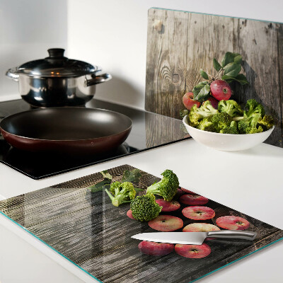Chopping board glass Apples on a wooden background