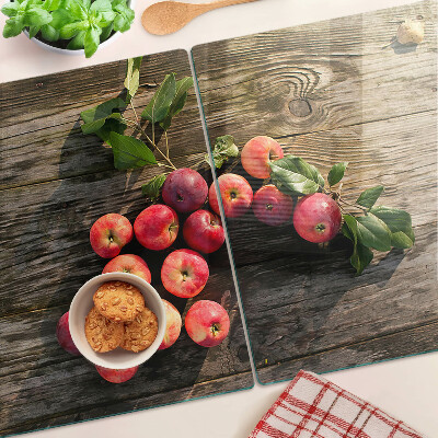Chopping board glass Apples on a wooden background