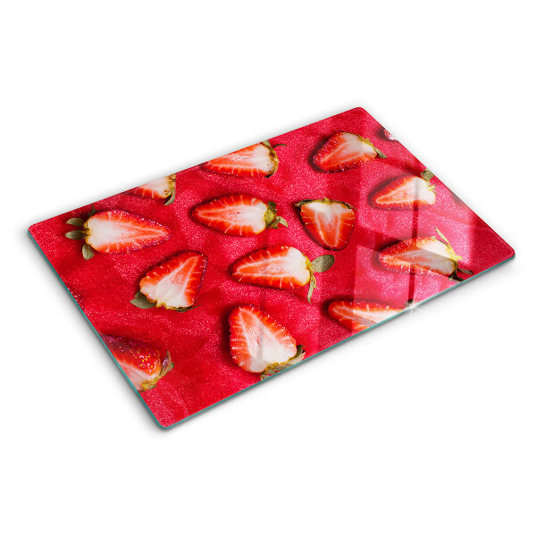 Chopping board glass Strawberries on a pink background