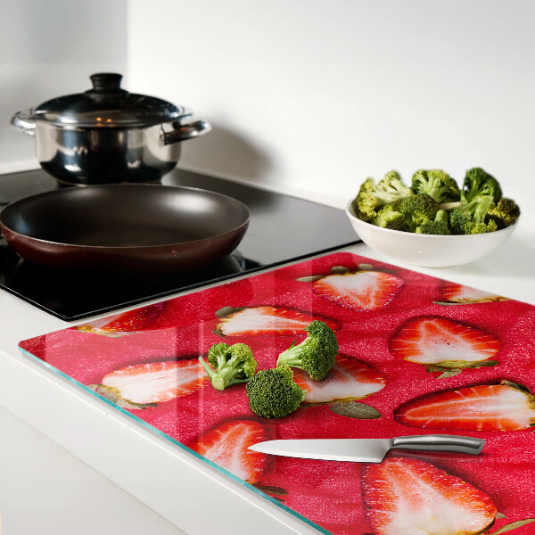 Chopping board glass Strawberries on a pink background