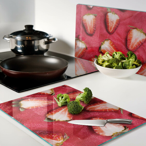 Chopping board glass Strawberries on a pink background