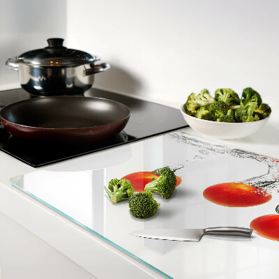 Glass chopping board Tomatoes in water