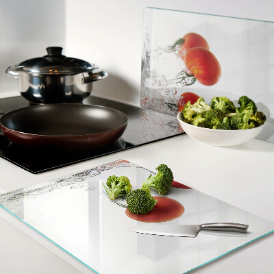 Glass chopping board Tomatoes in water