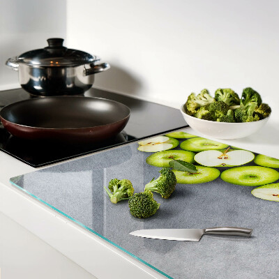 Cutting board Green apples on a gray surface