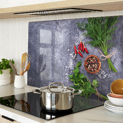 Glass chopping board Herbs and spices on a stone background