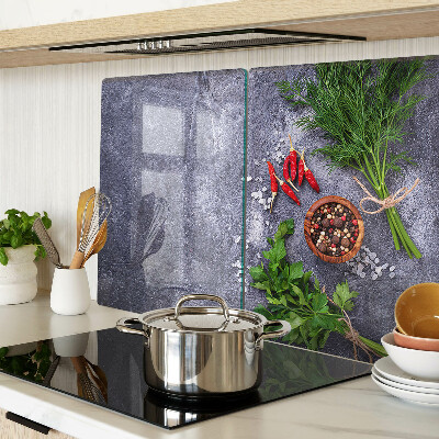 Glass chopping board Herbs and spices on a stone background