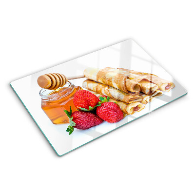 Glass cutting board Pancakes with honey and strawberries