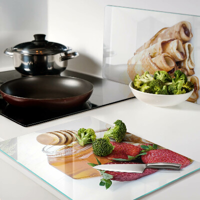 Glass cutting board Pancakes with honey and strawberries