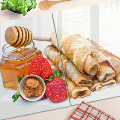 Glass cutting board Pancakes with honey and strawberries