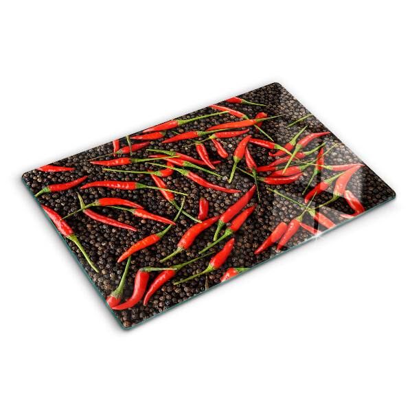 Cutting board Chili peppers on black pepper