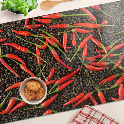 Cutting board Chili peppers on black pepper