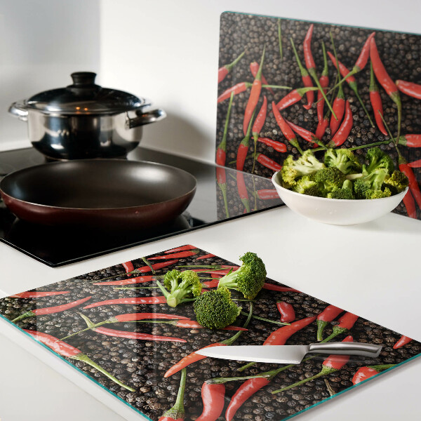 Cutting board Chili peppers on black pepper