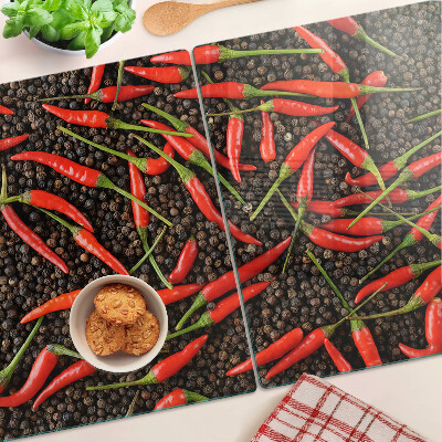 Cutting board Chili peppers on black pepper
