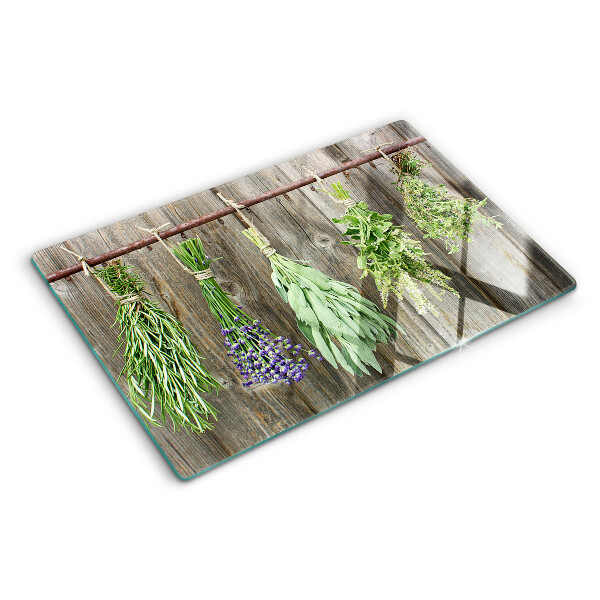 Glass cutting board Herbs on a wooden background