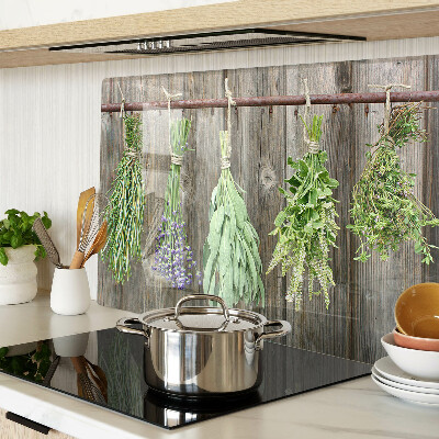Glass cutting board Herbs on a wooden background