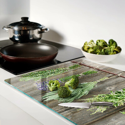 Glass cutting board Herbs on a wooden background