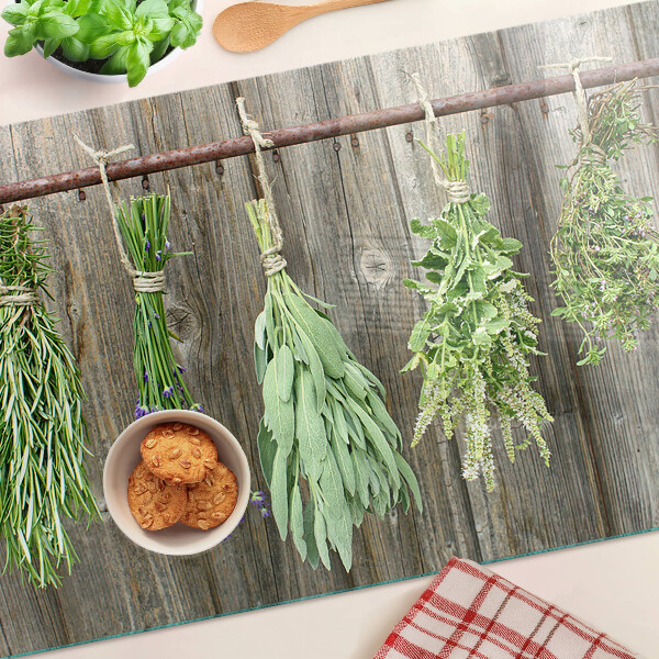 Glass cutting board Herbs on a wooden background