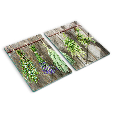 Glass cutting board Herbs on a wooden background