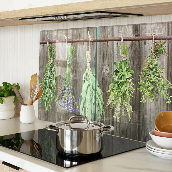 Glass cutting board Herbs on a wooden background