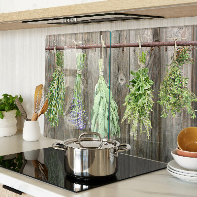Glass cutting board Herbs on a wooden background