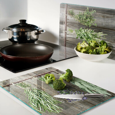 Glass cutting board Herbs on a wooden background