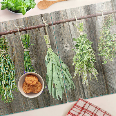 Glass cutting board Herbs on a wooden background