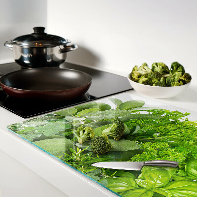 Chopping board glass Green herbs and leaves