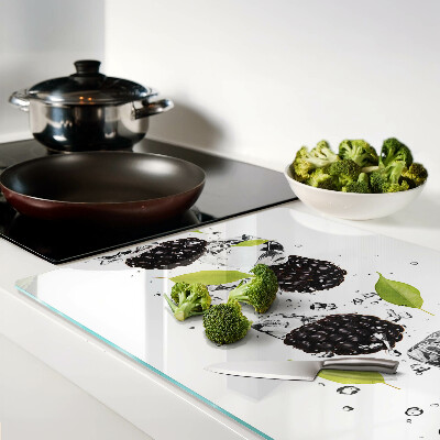 Glass cutting board Raspberries with leaves and drops of water