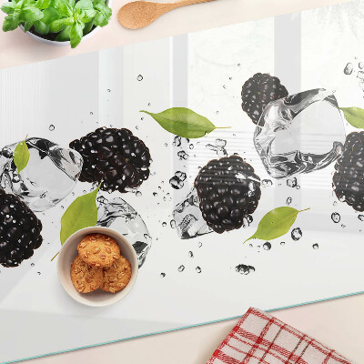 Glass cutting board Raspberries with leaves and drops of water