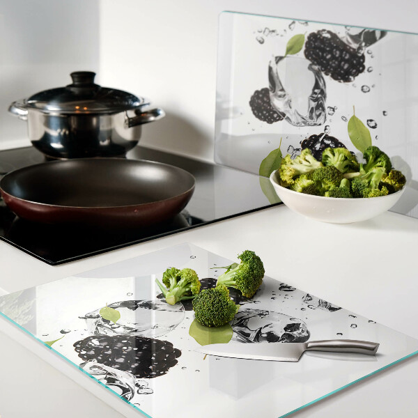 Glass cutting board Raspberries with leaves and drops of water